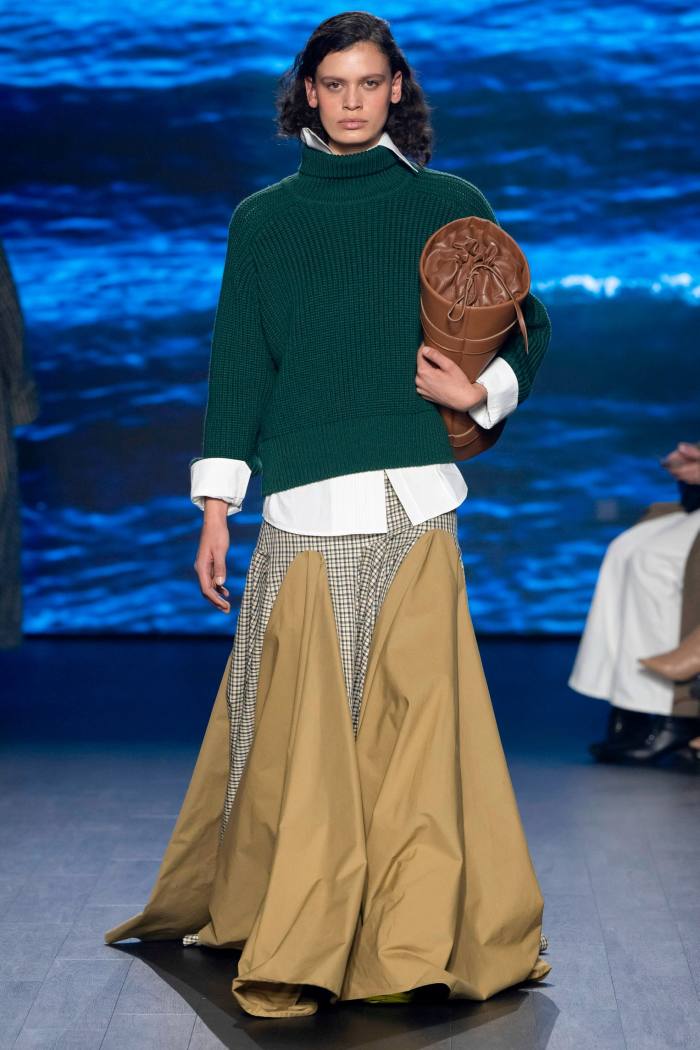 Model in chunky sweater over full length skirt