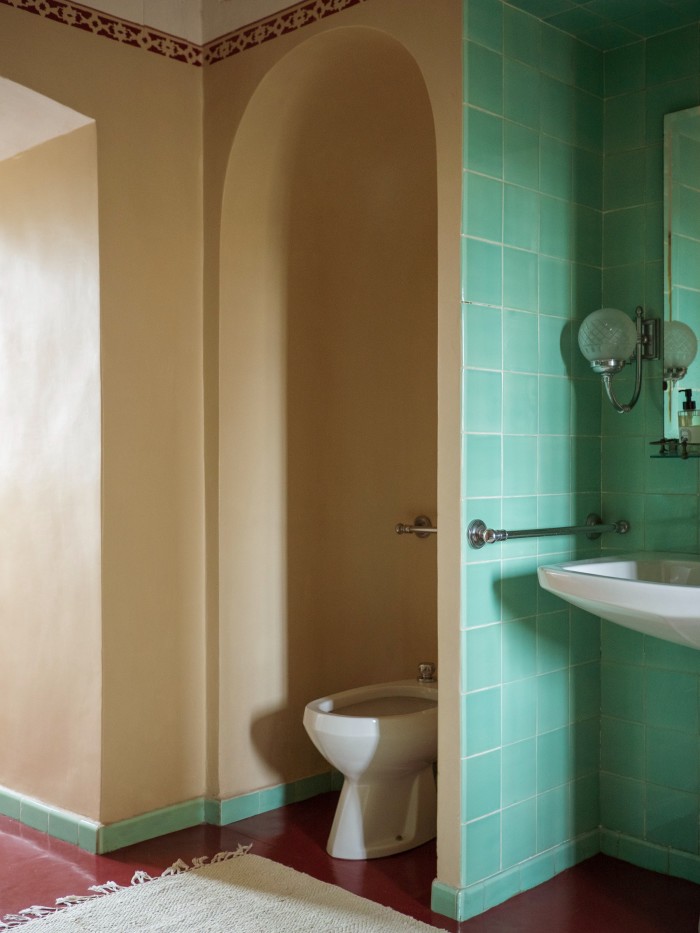 A green-tiled bathroom connected to the Madonna room