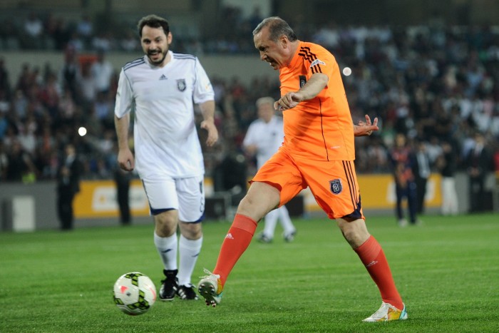 Recep Tayyip Erdogan (R) kicks the ball next to Turkish businessman Beraat Albayrak 