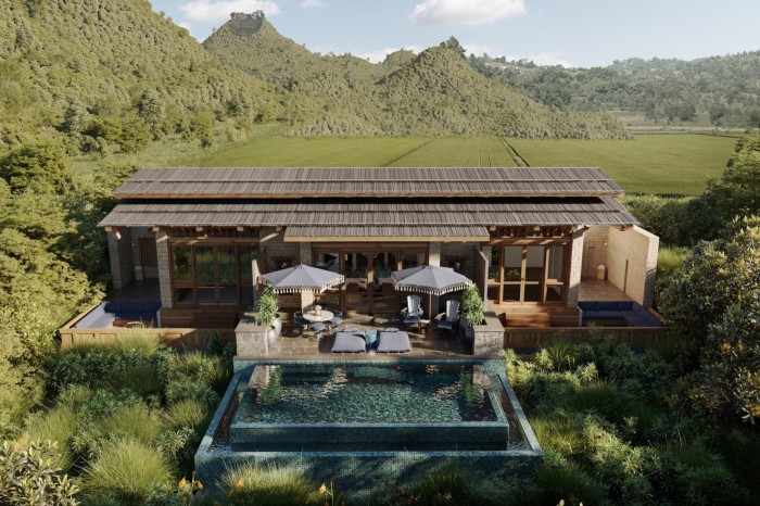A single-story villa surrounded by lush greenery