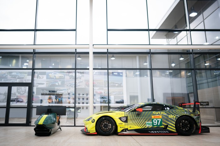 The Curv AMR-C01 race simulator next to an Aston Martin Vantage GTE