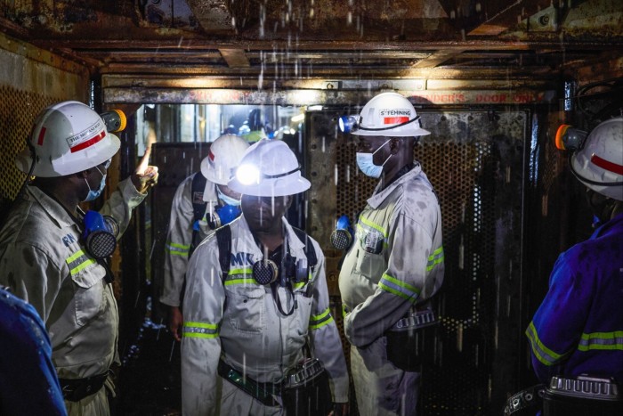 Workers ride the Henderson shaft elevator underground at the Mufulira mine, operated by Mopani Copper Mines, in Mufulira in May last year
