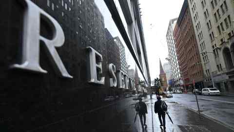 A pedestrian walks past the Reserve Bank of Australia in Sydney