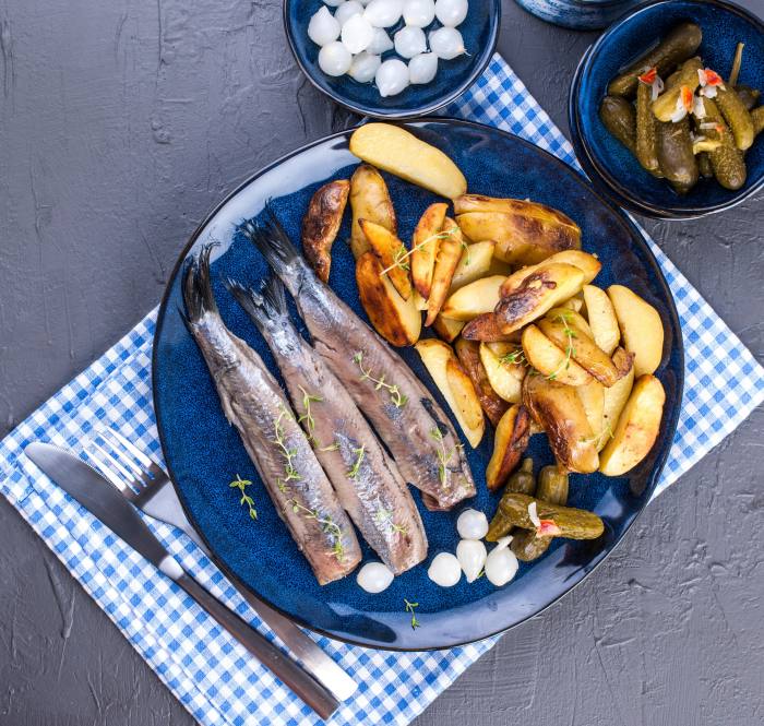 Herring fillets, potato wedges, pickled cucumbers and onions - traditional in the Netherlands