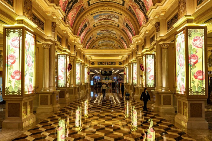 Staff walk down the hallway of The Venetian Macau casino after it was locked down due to the coronavirus pandemic. Macau’s daily gross gaming revenues for the first three weeks of November were running at roughly $30m per day, against $100m in 2019
