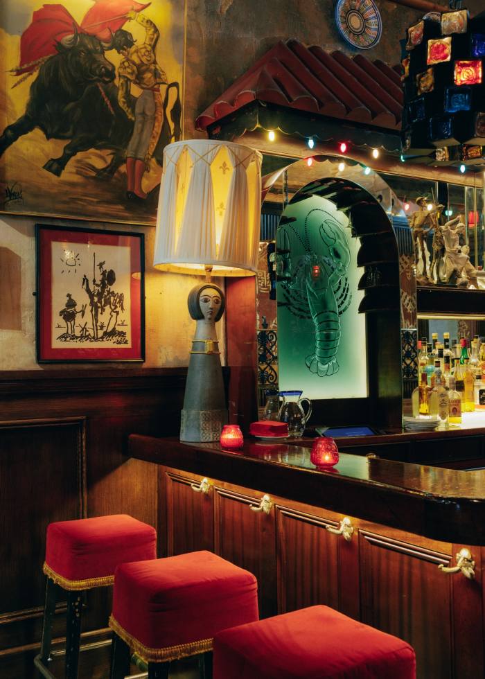 Seats at the bar of El Quijote Restaurant at the Chelsea Hotel