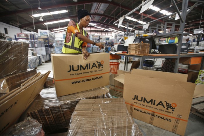 Un trabajador empaca productos en cajas de cartón de marca en un almacén de distribución de Jumia Technologies en Lagos, Nigeria.