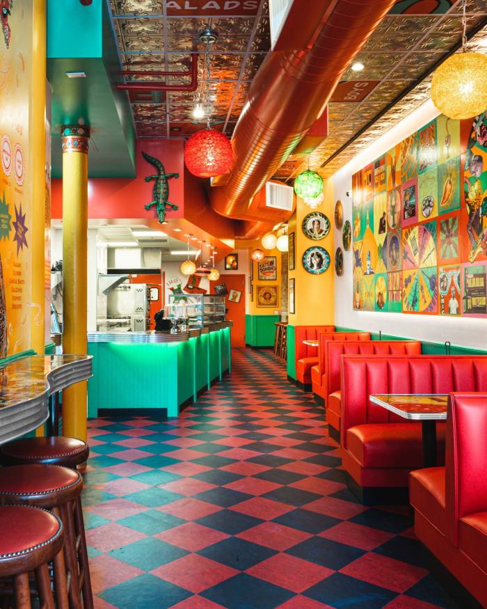 The Technicolor red, green, yellow and blue interior of New York’s Two Boots pizzeria