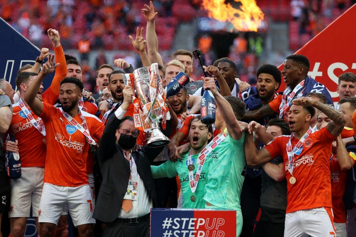 Simon Sadler owner of Blackpool, lifts the trophy with the team after winning the Sky Bet League One Play-off Final match at Wembley in 2021