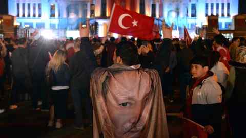 Supporters of Turkish President Recep Tayyip Erdogan gather in front of the presidential palace in Ankara