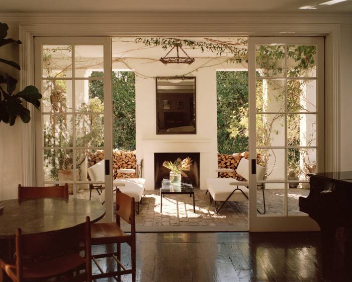 The sitting room and covered seating area decked in wisteria