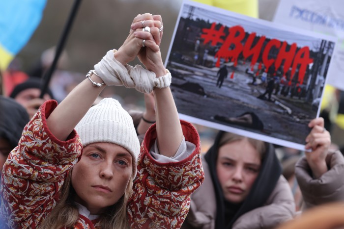 European protesters reference the killings in Bucha by walking with their hands tied with white cloth