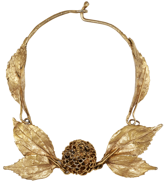 A large sculptural gold necklace with a round dahlia flower and leaves on the front