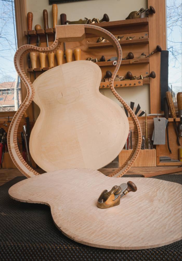 The top and base of a guitar ready to be joined together