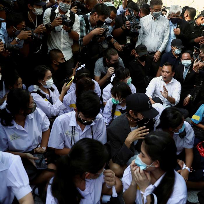 Education Minister Nataphol Teepsuwan talks with students as they protest outside the Education Ministry in Bangkok last week