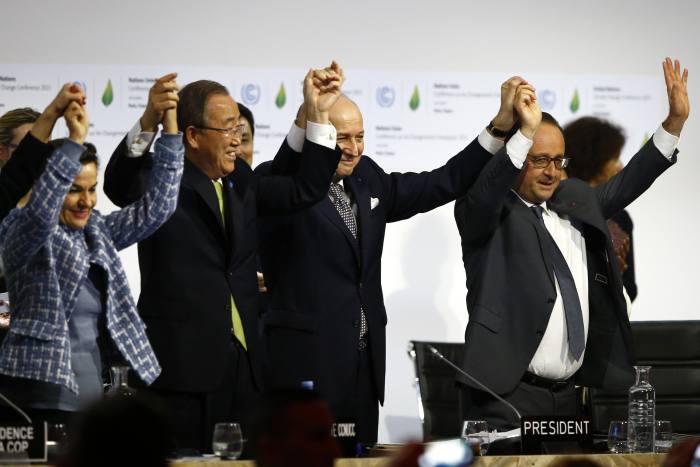 French President Francois Hollande, right, French Foreign Minister and president of the COP21 Laurent Fabius, second, right, United Nations climate chief Christiana Figueres and United Nations Secretary General Ban ki-Moon hold their hands up