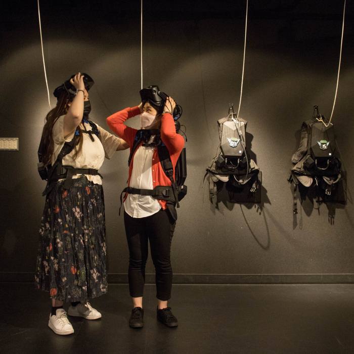 Two female gamers wearing VR headsets at Tokyo Joypolis