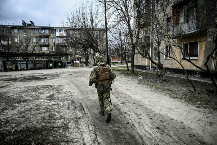 A Ukrainian soldier walking alone