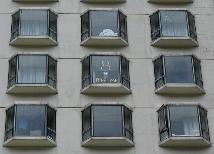 Messages posted on the windows of quarantined guests at a hotel in Hong Kong
