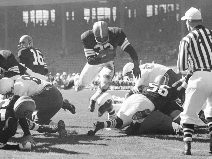 Jim Brown in action bridging the gap between the other players