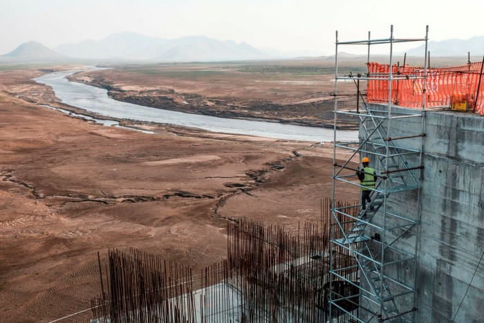 A worker on a construction ladder at the Grand Ethiopian Renaissance Dam, near Guba in Ethiopia