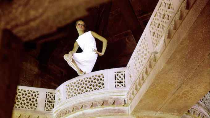 The inspiration: model Veruschka posing on a carved stone balcony in India for Vogue, 1964