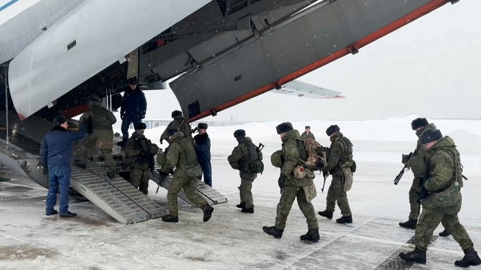 Russian paratroopers board a military plane near Moscow to Kazakhstan