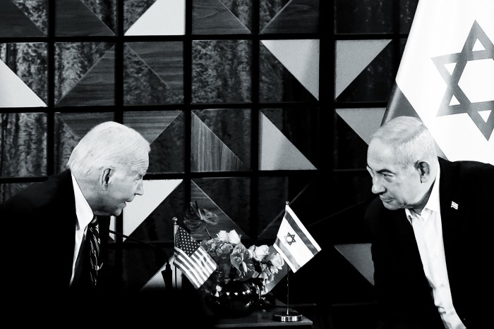Joe Biden and Benjamin Netanyahu seated and leaning towards each other across a table