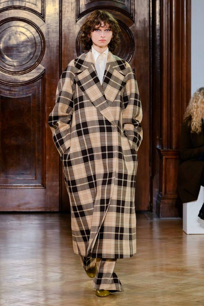 Model in voluminous check coat