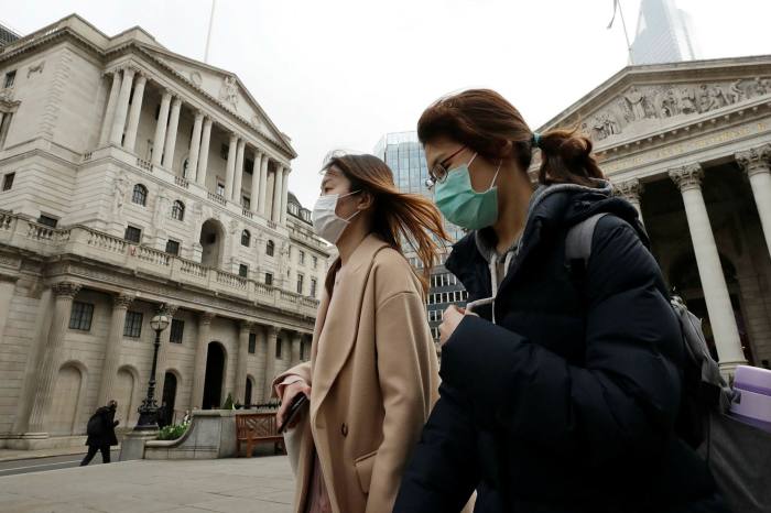 Pedestrians walk past the Bank of England during the first Covid lockdown of March 2020.
