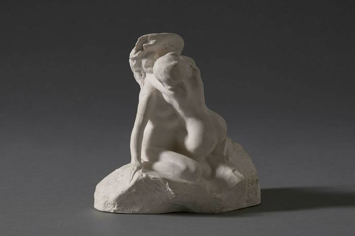 A white plaster sculpture of two figures entwined