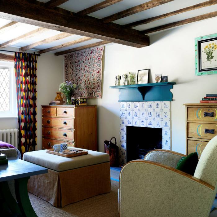 Designer Beata Heuman used Delft tiles on the fireplace of a cottage in Sussex