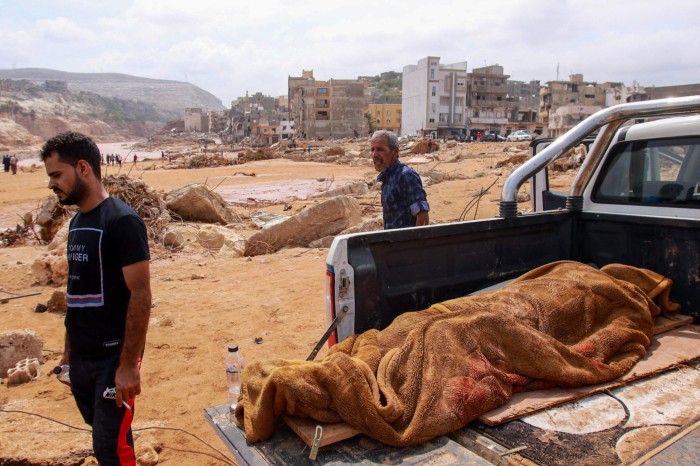 The body of a flood victim placed in the back of a truck in Derna, Libya 