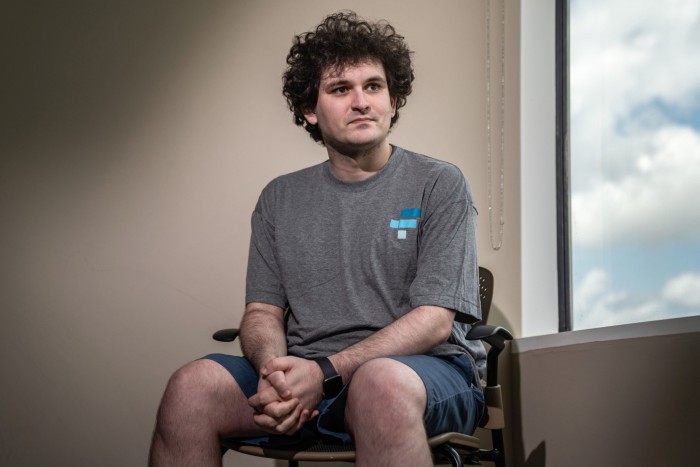 Sam Bankman-Fried sits in a chair in Hong Kong