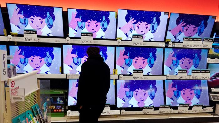 A shopper looks at televisions in a store in Indianapolis, US