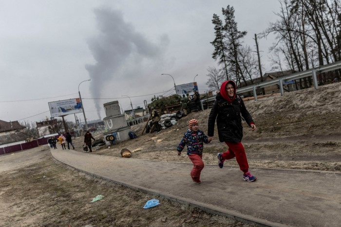 Residents run for cover after heavy shelling on the town of Irpin, near Kyiv, in March