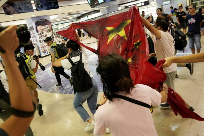 Anti-government protesters destroy a Chinese flag at a protest in Hong Kong last year