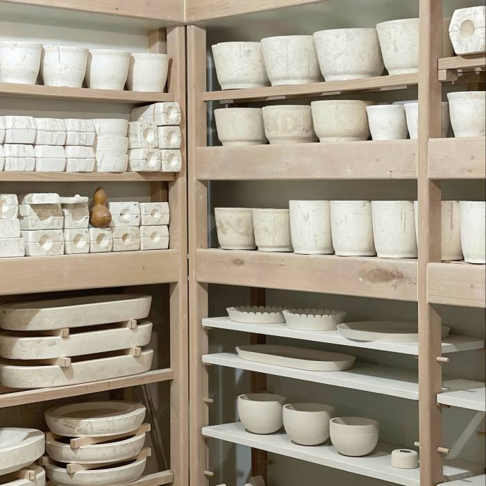 Ceramics on shelves at Le Petit Atelier de Paris
