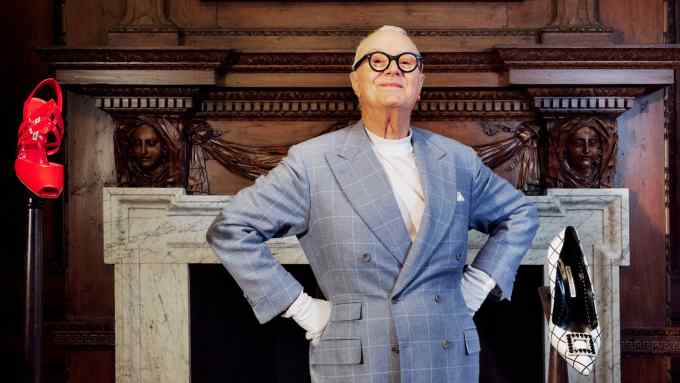 Manolo Blahnik at his company’s new headquarters at 31 Old Burlington Street, surrounded by shoes and sketches. He wears a suit by Anderson & Sheppard
