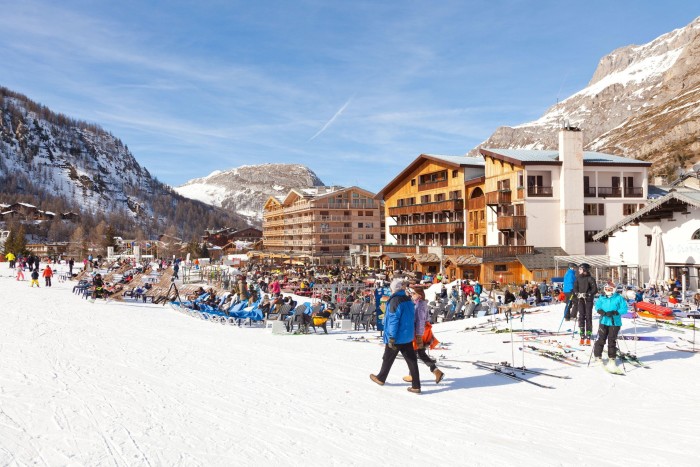 snowy, crowded ski resort on a sunny day