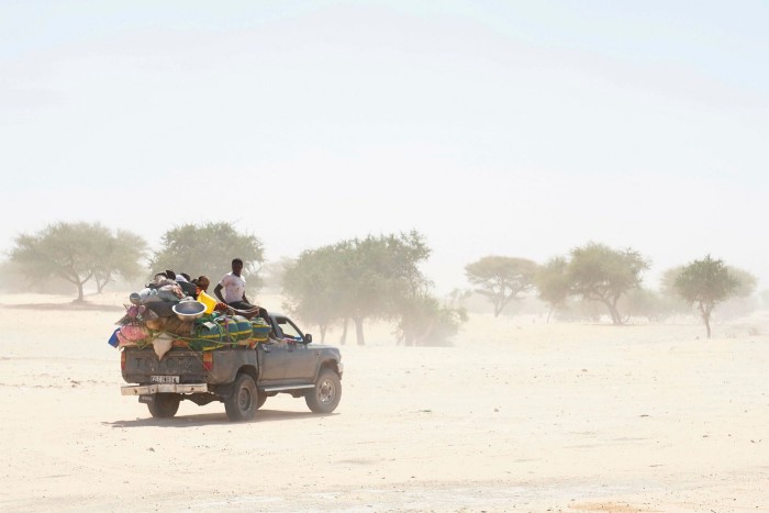 Chadian travels on an overloaded truck across the desert on the way to Bol, in southern Chad