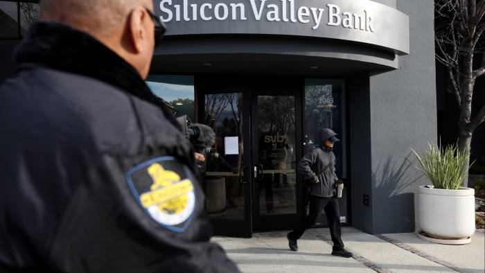 A security guard watches a customer leave a Silicon Valley Bank office in Santa Clara, California