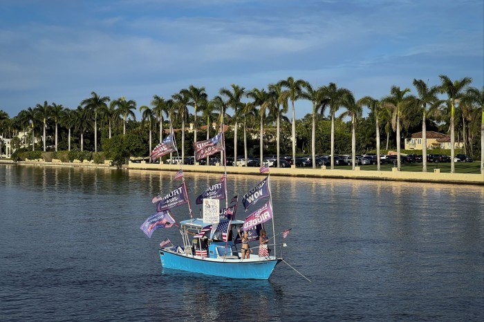 A group of Trump supporters in a boat adorned with flags reading ‘Trump Won’. The boat is sailing past Mar-a-Lago, Trump’s member-only-club-cum campaign- headquarters in Palm Beach