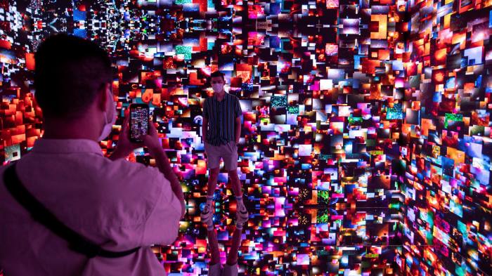 Visitors engage with ‘Machine Hallucination Space: Metaverse Lot 1’, by digital artist Refik Anadol, at Digital Art Fair Asia in Hong Kong
