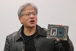 Jensen Huang, Nvidia CEO, holding one of its chips