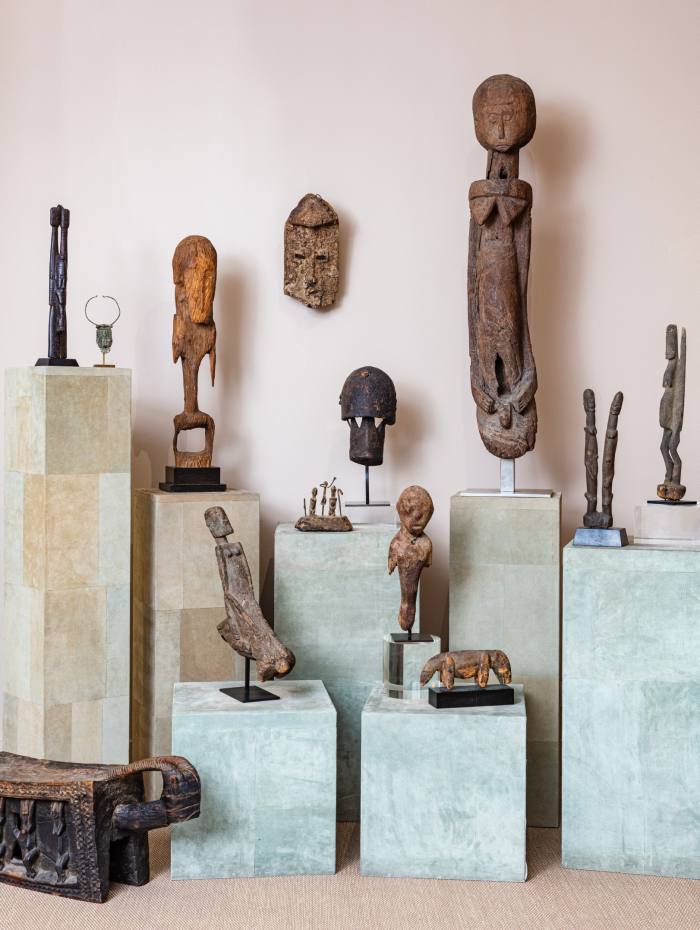 Many African sculptures on plinths