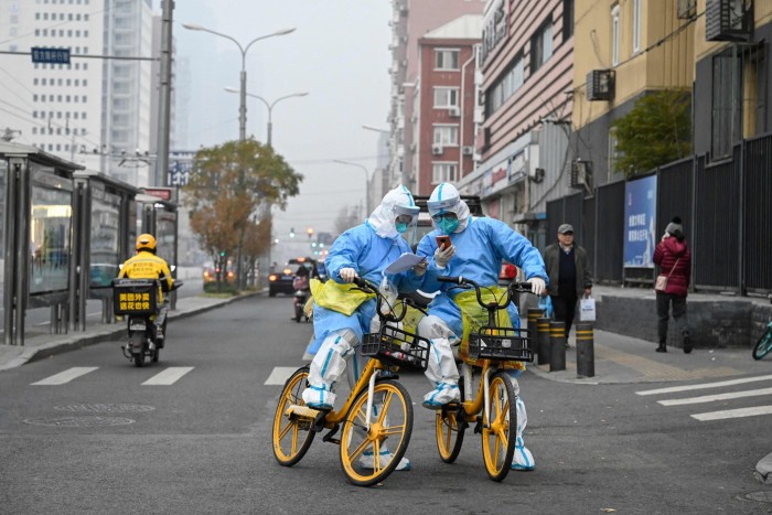 Health workers in Beijing carry Covid-19 testing equipment on bicycles. If China were to ease its restrictions next year, its demand for oil and gas could soar