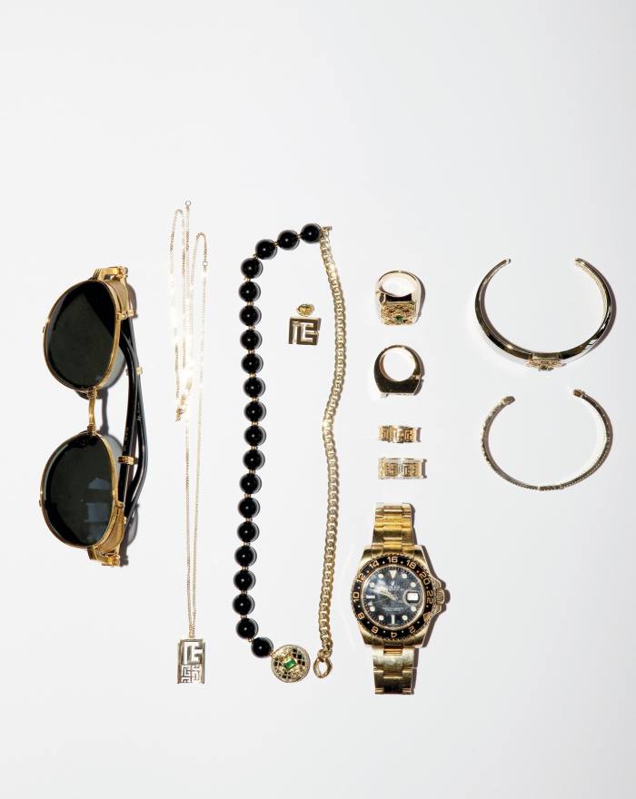 Sunglasses, pendant, onyx beads, rings, wristwatch, and bangles