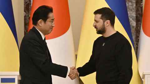 Japanese Prime Minister Fumio Kishida and Ukrainian President Volodymyr Zelensky greet each other after their joint press conference in Kyiv, March 21, 2023.