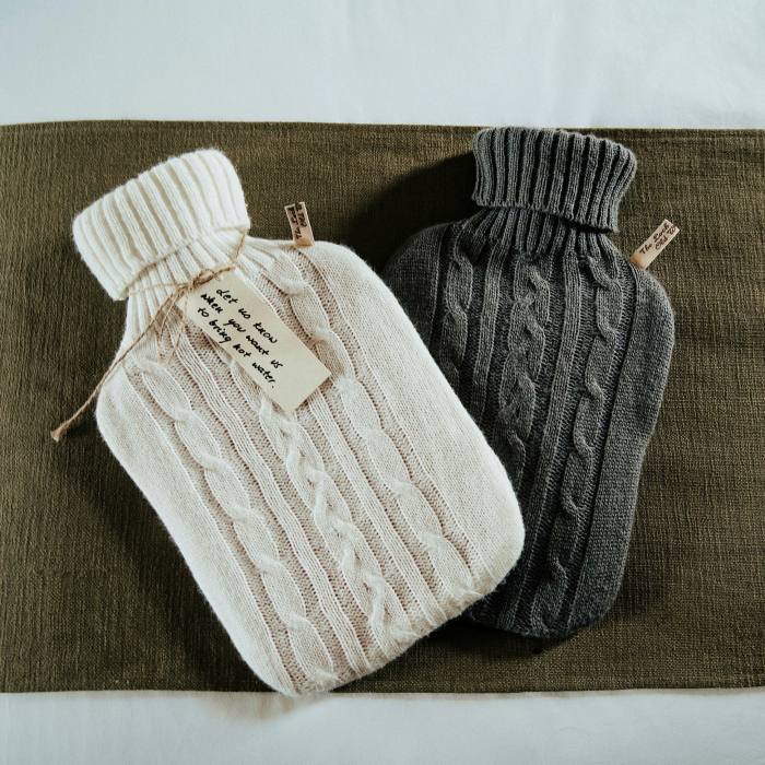 Hot-water bottles in knitted covers in one of The Loch & The Tyne’s guest rooms